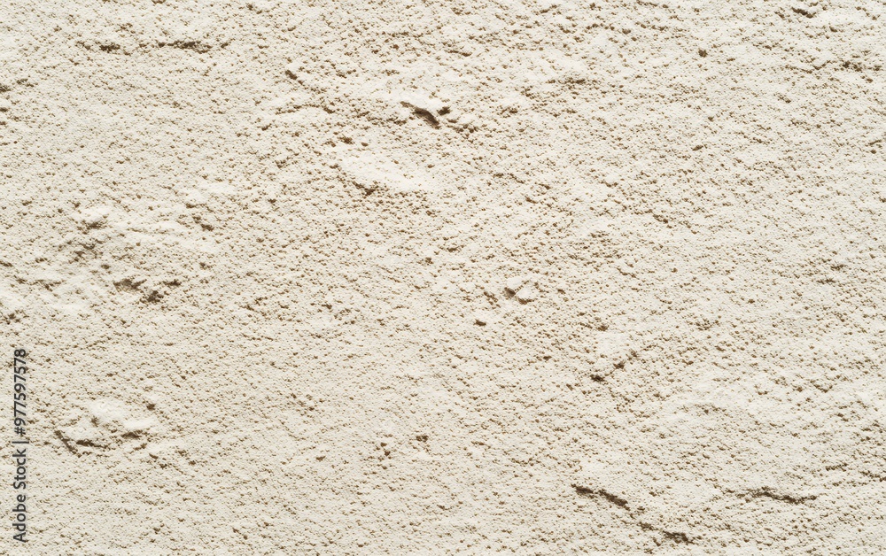 A close-up shot of a powdery, light beige surface. A close-up shot of a powdery, light beige surface.
