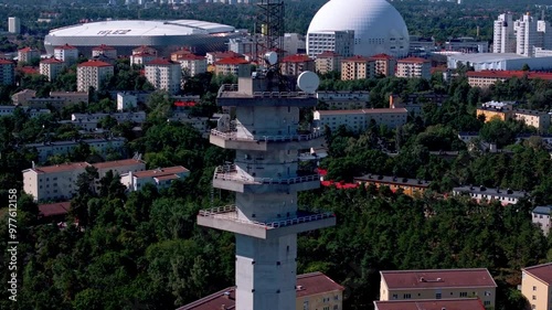 Aerial view showcasing a communication tower above Stockholm's urban landscape, highlighting landmarks such as the Ericsson Globe and Tele2 arena photo