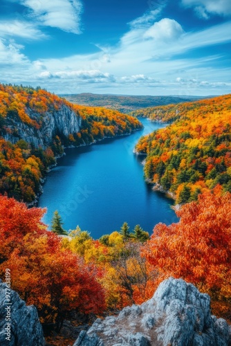 Autumn colors by the serene river in a mountainous landscape