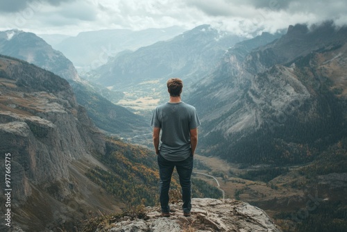 Exploring Nature - Hiker Stands On Top of Mountain looking out 