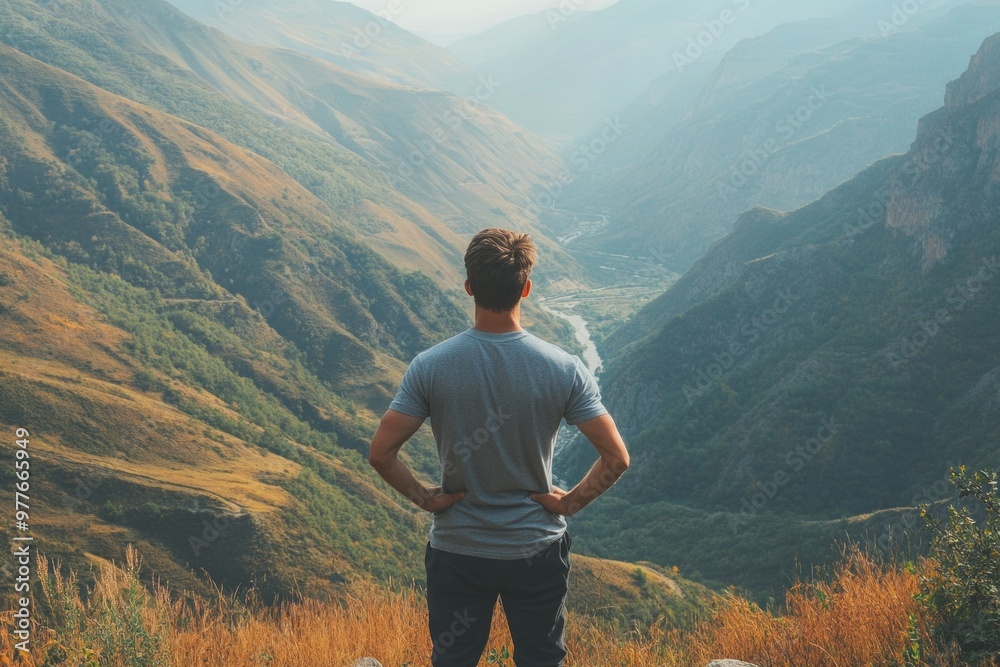 Exploring Nature - Hiker Stands On Top of Mountain looking out Exploring Nature - Hiker Stands On Top of Mountain looking out