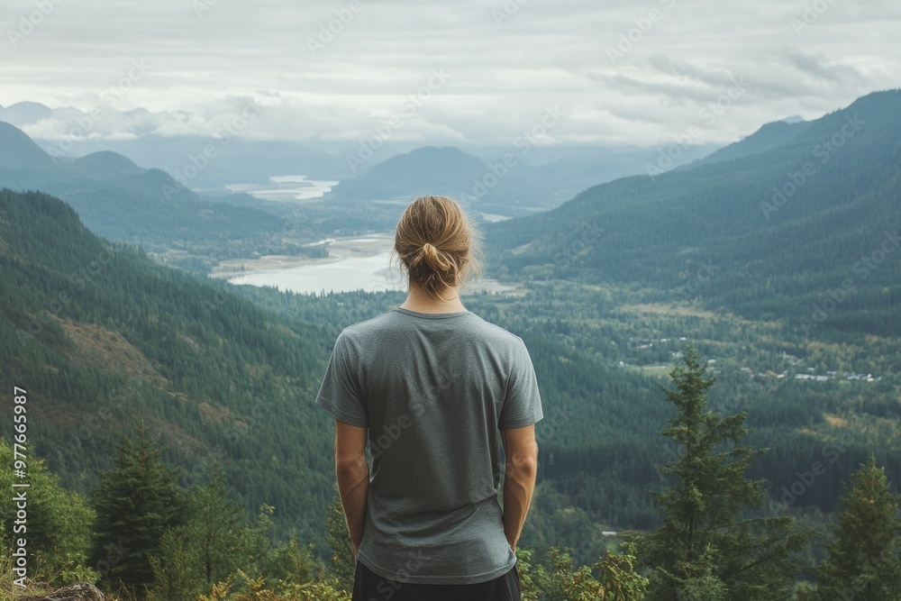 Exploring Nature - Hiker Stands On Top of Mountain looking out Exploring Nature - Hiker Stands On Top of Mountain looking out