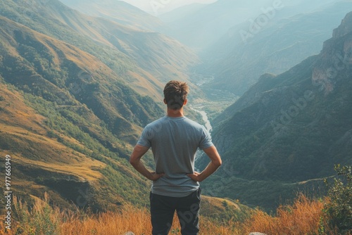 Exploring Nature - Hiker Stands On Top of Mountain looking out 