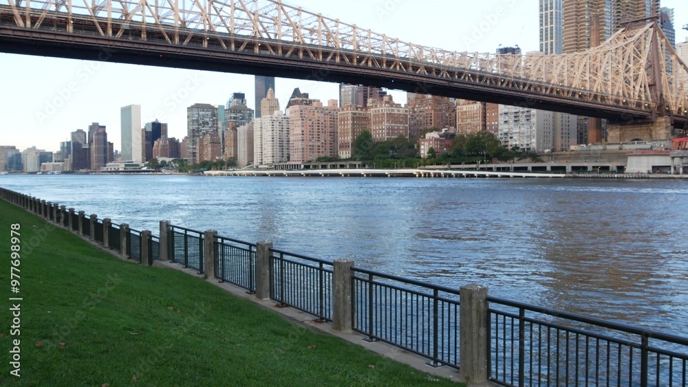 Obraz premium New York City waterfront skyline, Queensboro Bridge, Manhattan Midtown buildings, riverfront skyscrapers. Waterside cityscape view from Roosevelt Island. United States architecture and real estate.