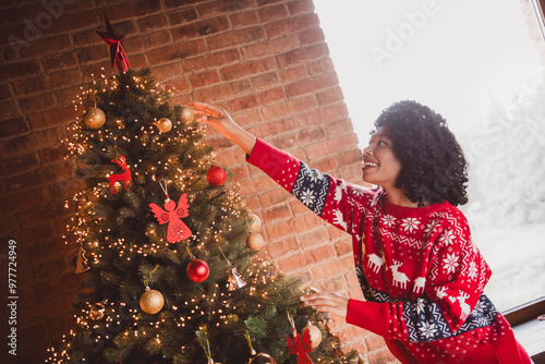 Photo of nice young girl decorate tree wear red christmas clothes enjoy modern cozy x-mas party decoration interior flat indoors