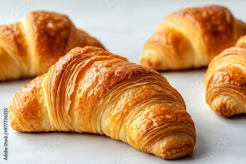 Freshly baked golden croissants on a light background.