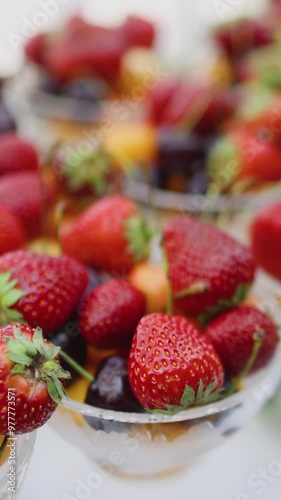 Beautifully decorated banquet catering table, assortment variety of berries with cherry, strawberry, raspberry and apricot, on luxury birthday party event or wedding reception celebration photo