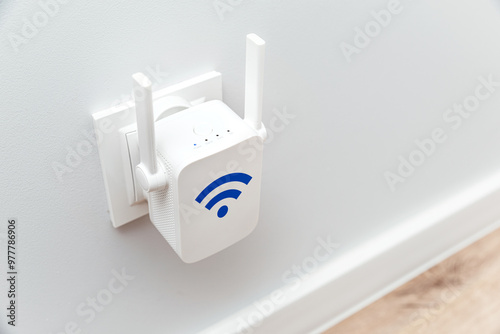 Schilderij op canvas Wireless Wi-Fi repeater on white wall indoors