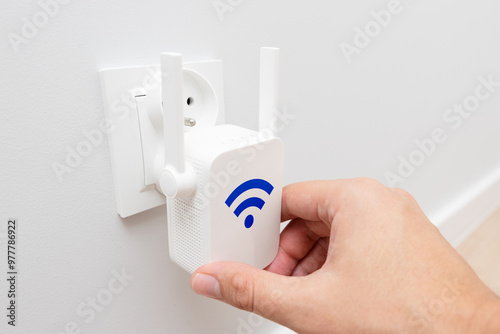 Konstfotografi Wireless Wi-Fi repeater on white wall indoors