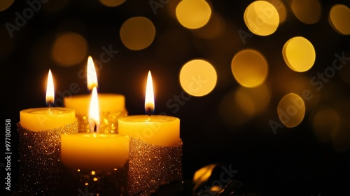 Advent candles glowing in darkness with sparkling flames and blurred abstract lights photo