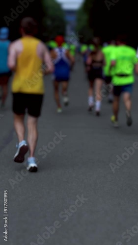 Marathon runners crowd, sportsmen participants start running the half-marathon in the city streets, crowd of sportswomen joggers in motion, group athletes outdoor training competition in a summer day