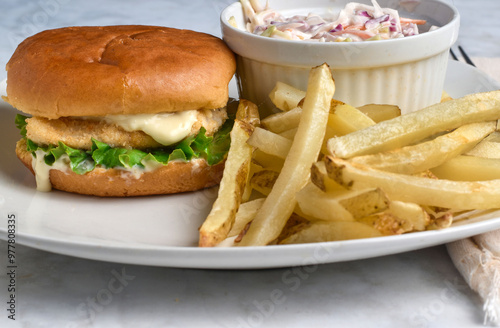 haddock fillet sandwich  with cole slaw and fries photo