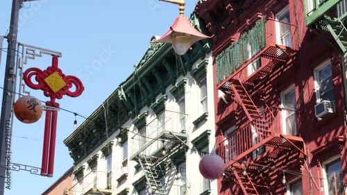 New York City, United States. Manhattan Chinatown Mott street, chinese ethnic district buildings architecture, USA. American red brick house in little China. Fire escape ladder in NYC. Paper lanterns.