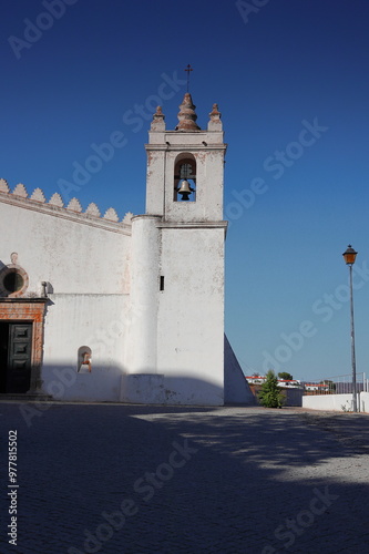 An old church in the town of Mértola in Portugal and a blue sky behind it  photo