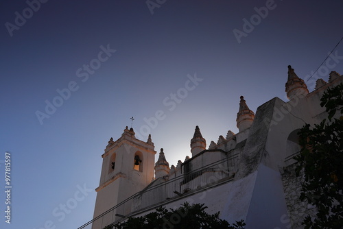 Towers of an old church in the town of Mértola in Portugal and a blue sky behind them  photo