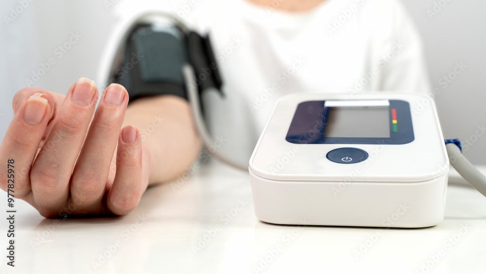 Woman measuring blood pressure with a tonometer Woman measuring blood pressure with a tonometer