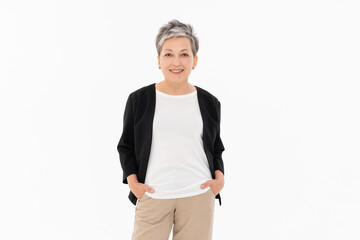 Smiling confident aged mature business woman standing isolated on white background. Old businesswoman, 50s grey haired lady professional female manager, leader looking at camera, copy space.