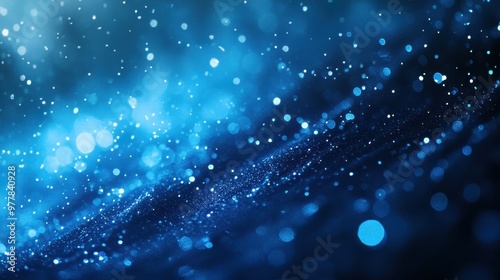 Abstract blue background with shimmering particles and light effects, creating a mesmerizing underwater or celestial atmosphere.