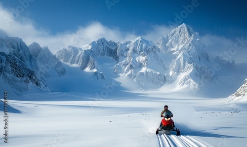 An adventurous person snowmobiling through a vast, snow-covered mountains photo