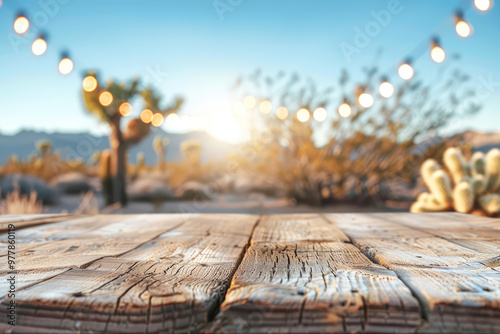 Cactus-filled desert at dusk, with a beautiful sky and a travel-inspired scene of garland lights and wooden table photo