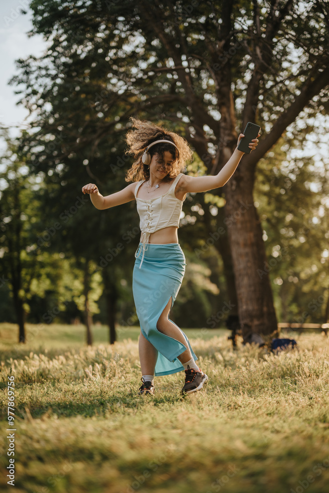 Gorgeous girl dancing energetically in a green park under the sun, embodying freedom and happiness. Gorgeous girl dancing energetically in a green park under the sun, embodying freedom and happiness.