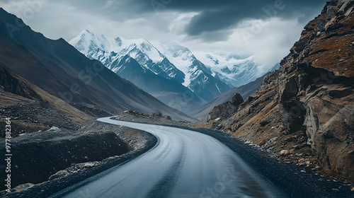 Wallpaper Mural A mountain pass winding through rocky terrain with distant snow-covered peaks on the horizon. Torontodigital.ca