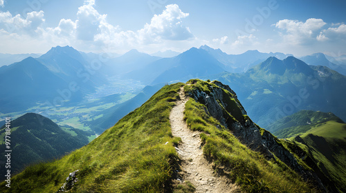 A narrow ridge trail running along the top of a steep mountain range with panoramic views of the valleys and peaks below.