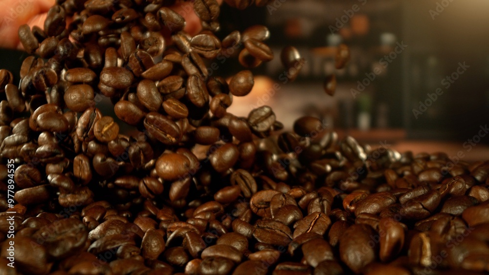Fototapeta premium Man hands throwing roasted coffee beans.