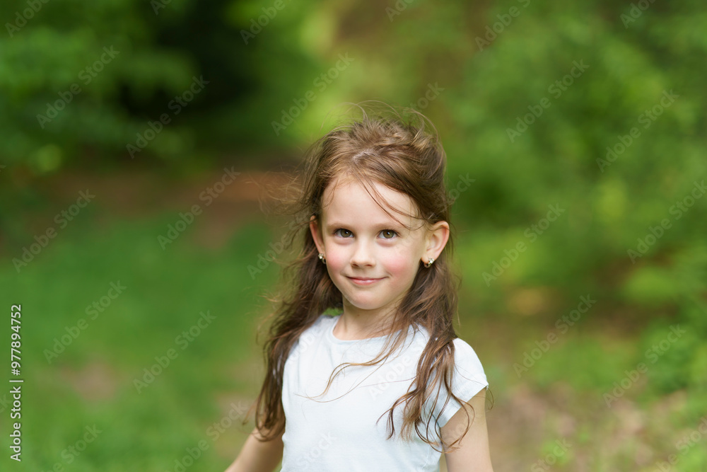 Little beautiful girl on the background of the road in the park. Happy childhood concept outdoors Little beautiful girl on the background of the road in the park. Happy childhood concept outdoors