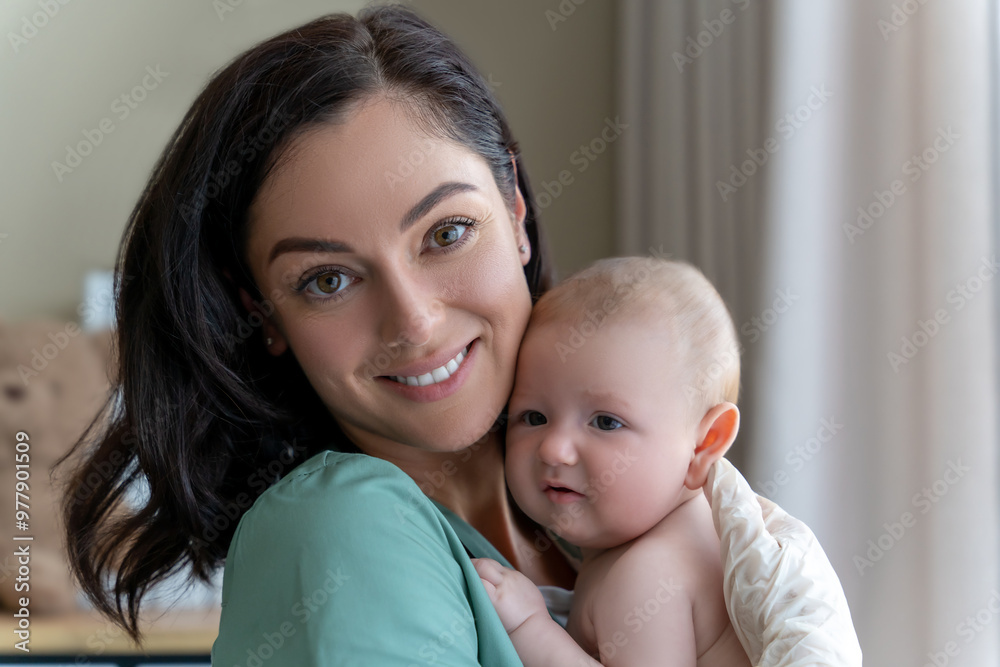 Beautiful nurse medical worker in gloves holding newborn baby in hands Beautiful nurse medical worker in gloves holding newborn baby in hands