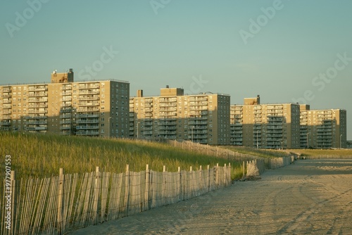 Grassy dunes and view of buildings at Rockaway Beach, Queens, New York