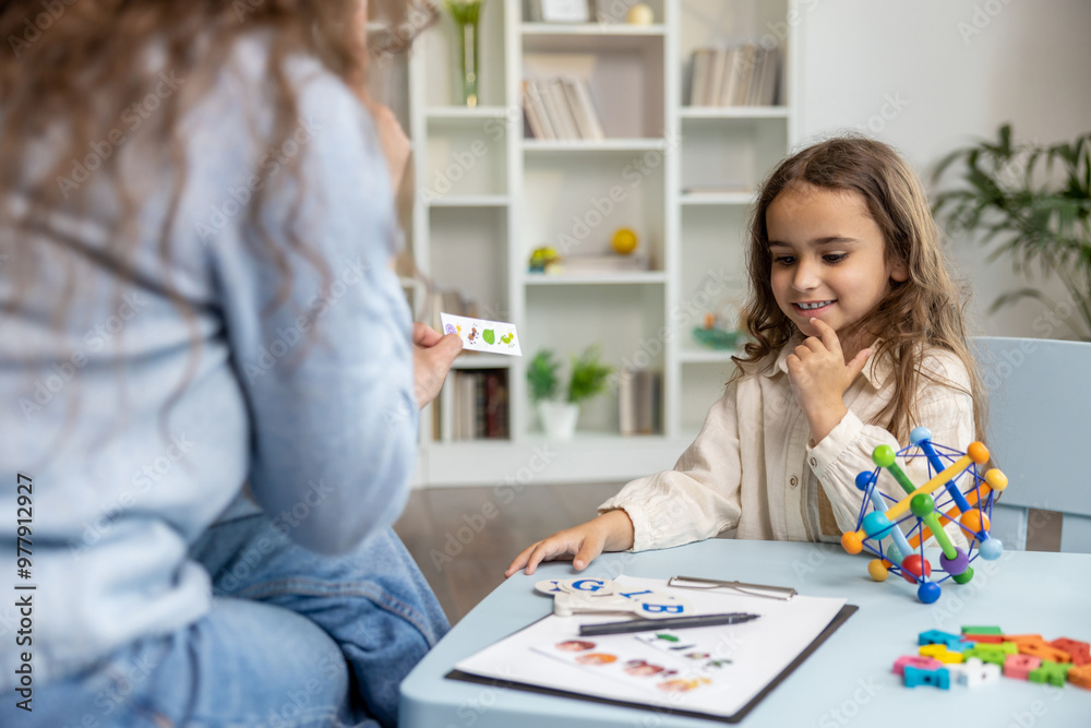 Female speech therapist having a training session with a long-haired girl Female speech therapist having a training session with a long-haired girl