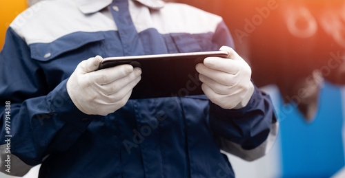 Industry operator use computer tablet for control and diagnostics drilling head of mine roadheader. Concept underground mining of coal and ore. photo