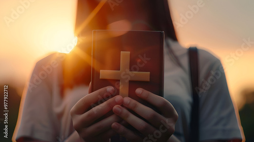 close-up of a woman praying and carrying a holy bible