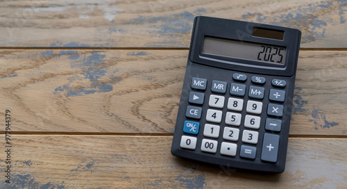 Calculator with the number 2025 on the display. Concept of finance, taxes, savings and economic crisis.
