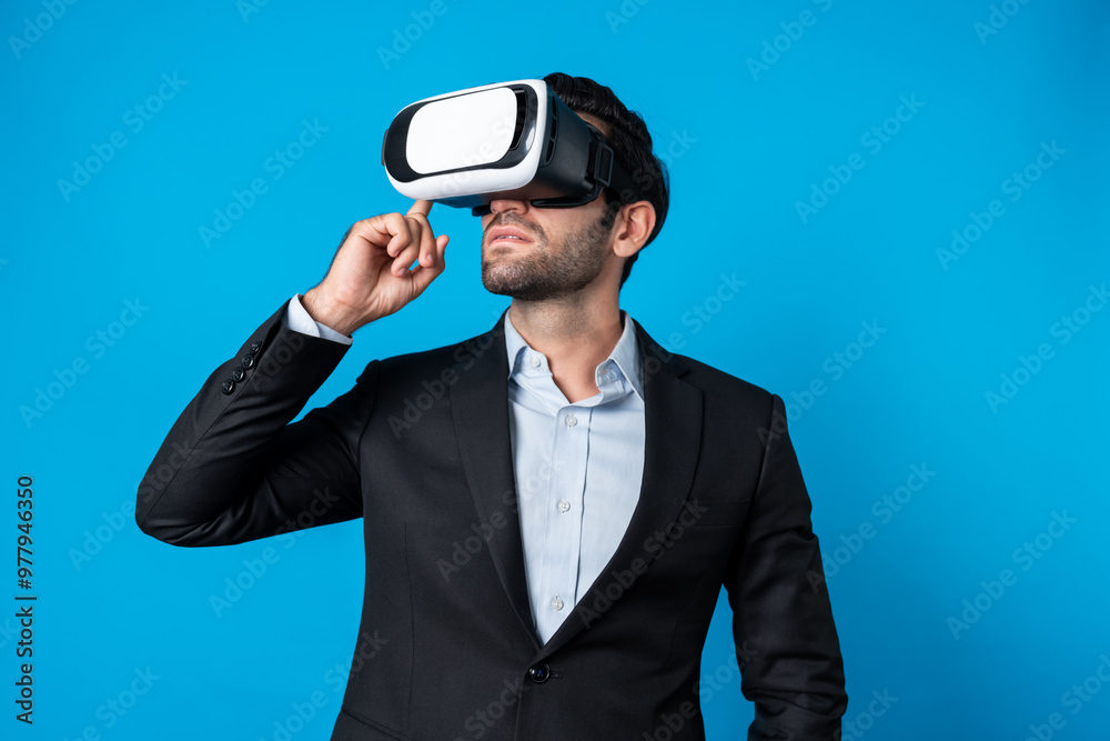 Caucasian business man planning financial plan while using VR goggle. Professional project manager standing and touching VR headset while using visual reality glasses to connect metaverse. Deviation. Caucasian business man planning financial plan while using VR goggle. Professional project manager standing and touching VR headset while using visual reality glasses to connect metaverse. Deviation.