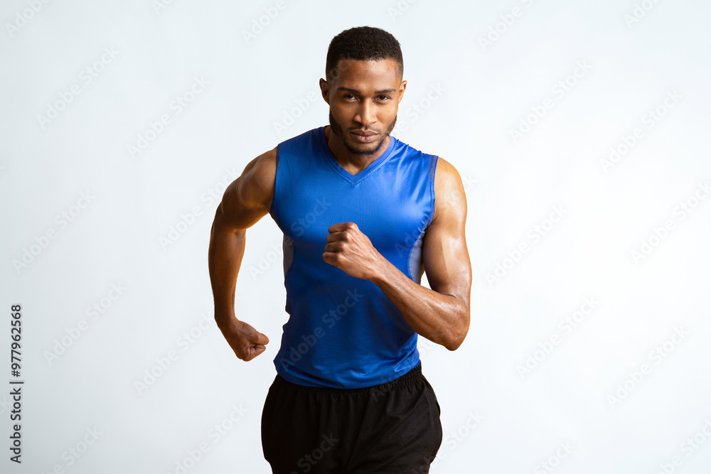 Move On. Confident afro sportsman getting ready for run, looking at camera isolated over yellow studio wall, copyspace Move On. Confident afro sportsman getting ready for run, looking at camera isolated over yellow studio wall, copyspace