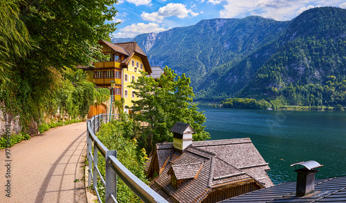 Hallstatt old town. Famous landmark in Austria. Scenic view from the road on lake Hallstattersee among Austrian Alps mountains with green forests. photo