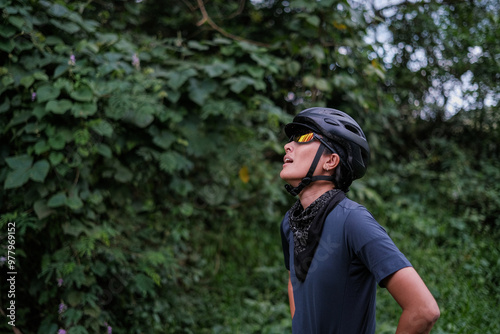 a young woman taking breather during her bike ride outdoors photo