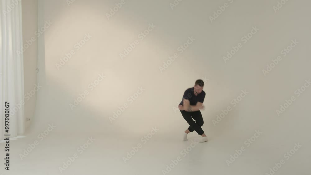 Dynamic Dance Movement Showcased Within a Minimalist Studio Setting for Artistic Expression