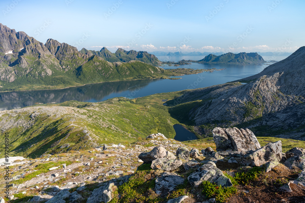 Obraz premium Rocky mountains with sea and lakes and rocks in front, Lofoten Norway