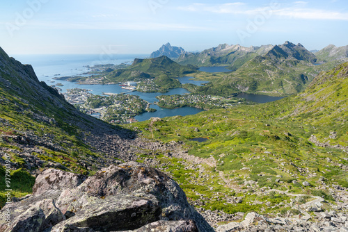 Rocky mountains with lakes and ocean with Svolvayer city view, Floya hiking trail near Djevelporten in Lofoten Norway