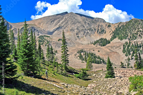 Hiker stands at the base of Colorado's Mount Sopris west of Aspen photo