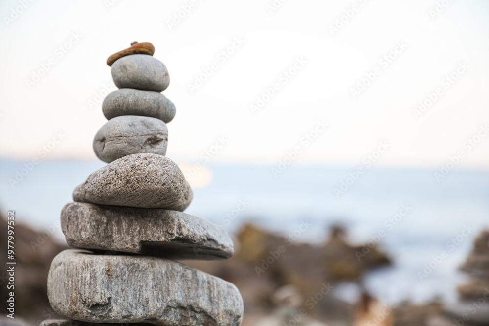 serene beach scene with smooth rocks stacked in a balanced formation. The tranquil atmosphere evokes a sense of zen, harmony, and peace, symbolizing balance and mindfulness in nature serene beach scene with smooth rocks stacked in a balanced formation. The tranquil atmosphere evokes a sense of zen, harmony, and peace, symbolizing balance and mindfulness in nature