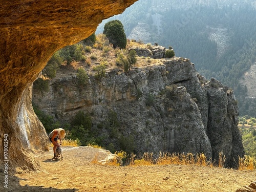 senior woman hiker and dog hiking in wind caves Logan Canyon Utah