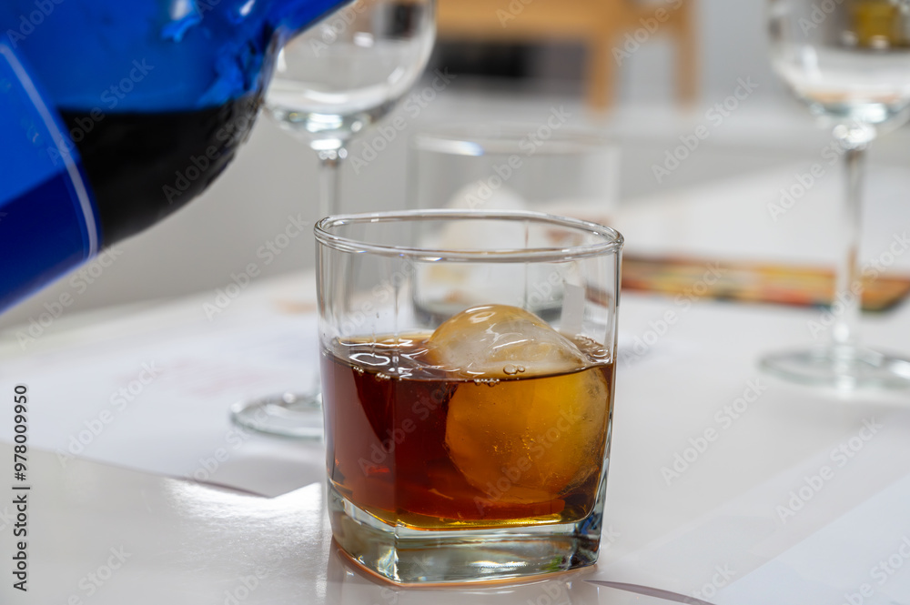 Tasting Sherry sweat cream wine on ice rocks, jerez fortified wine made from palomino white grape served in Jerez de la Frontera, Cadiz, Andalusia, Spain Tasting Sherry sweat cream wine on ice rocks, jerez fortified wine made from palomino white grape served in Jerez de la Frontera, Cadiz, Andalusia, Spain