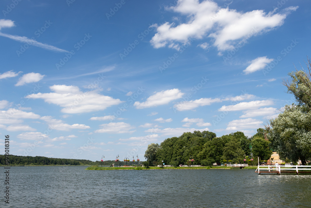 Summer landscape at Quay of Jezioro Berzyńskie lake in Wolsztyn, Greater Poland (Wielkopolska) covered in flowers.
