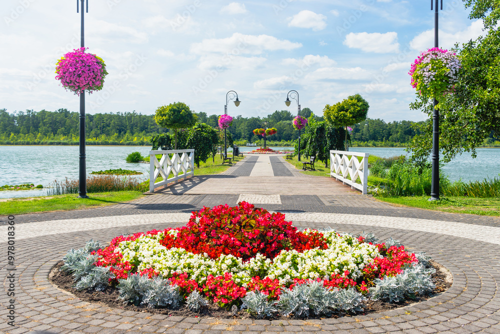 Summer landscape at Quay of Jezioro Berzyńskie lake in Wolsztyn, Greater Poland (Wielkopolska) covered in flowers.