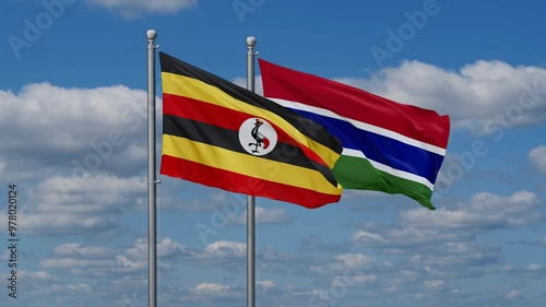 Gambia and Uganda flags flying together, video concept of the relationship, two country relations concept photo