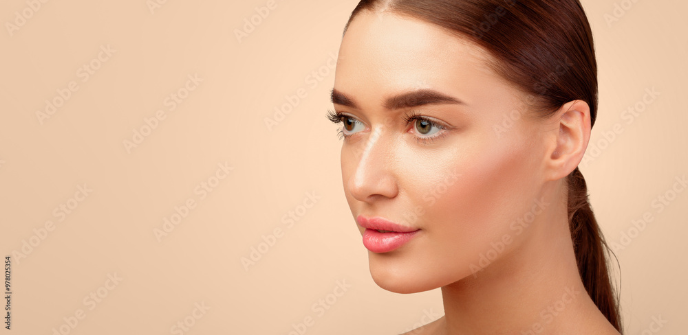 Naklejka premium Facial Skincare Offer. Gorgeous Young Lady With Natural Makeup And Perfect Face Skin Looking Aside At Empty Space For Text, Advertising Cosmetic Products On Gray Background. Studio Shot, Panorama
